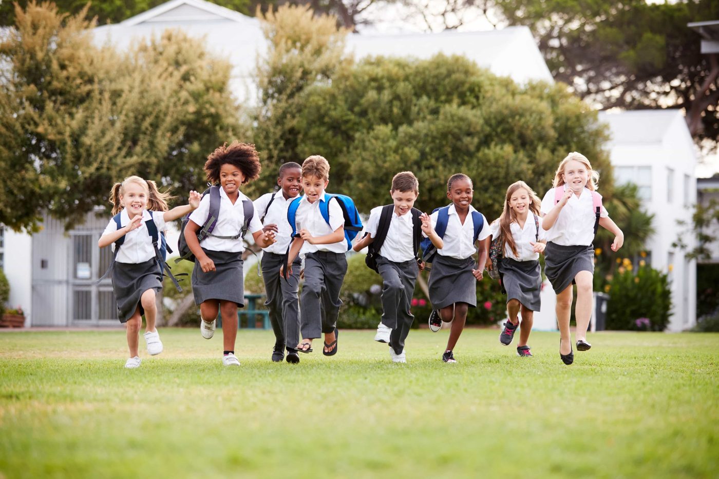 Children running across the school field