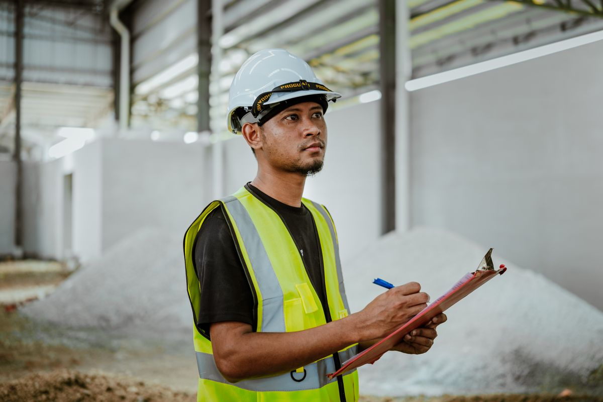 An engineer recording test readings on site