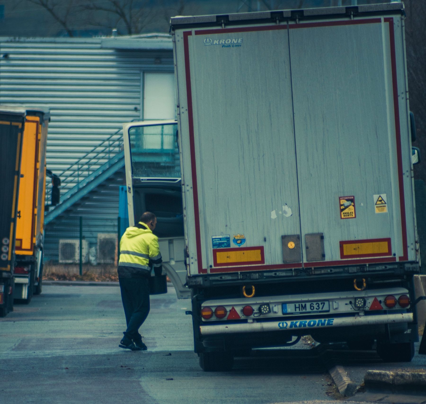 A rigid with its tail lift folded at the rear, in a
      commercial vehicle yard