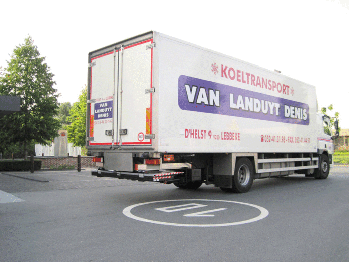A slider tail lift sliding out from beneath a vehicle body and unfolding into position