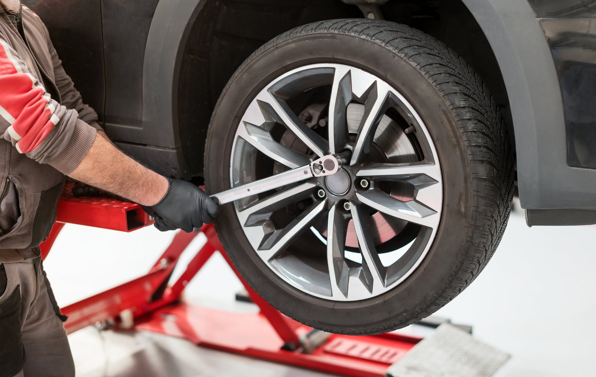 A mechanic torquing a wheel to specification