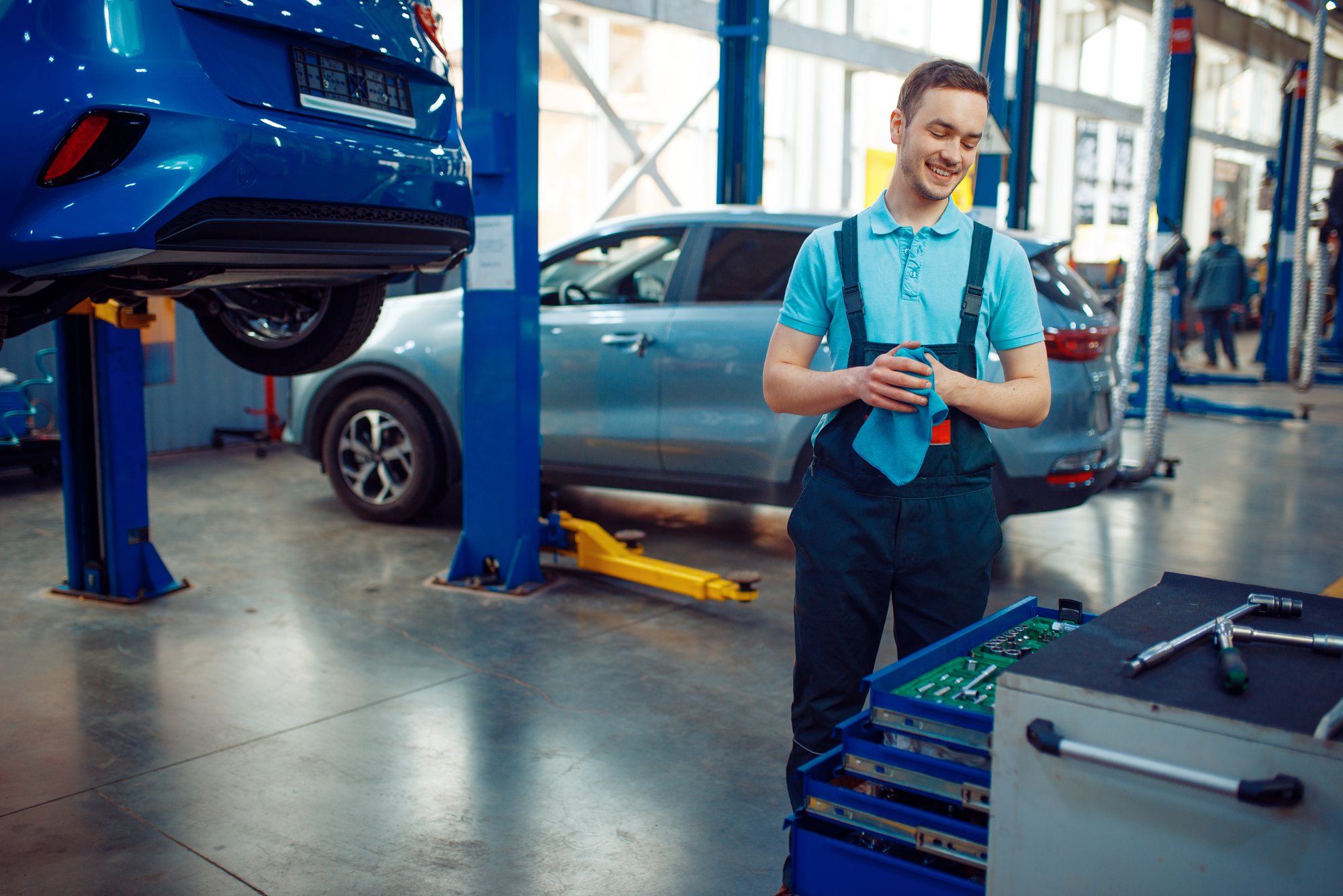 Vehicles up on lifts in a busy workshop