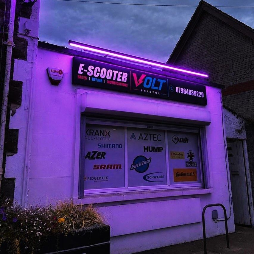 The Volt Bristol shopfront at dusk, its sign and windows lit purple