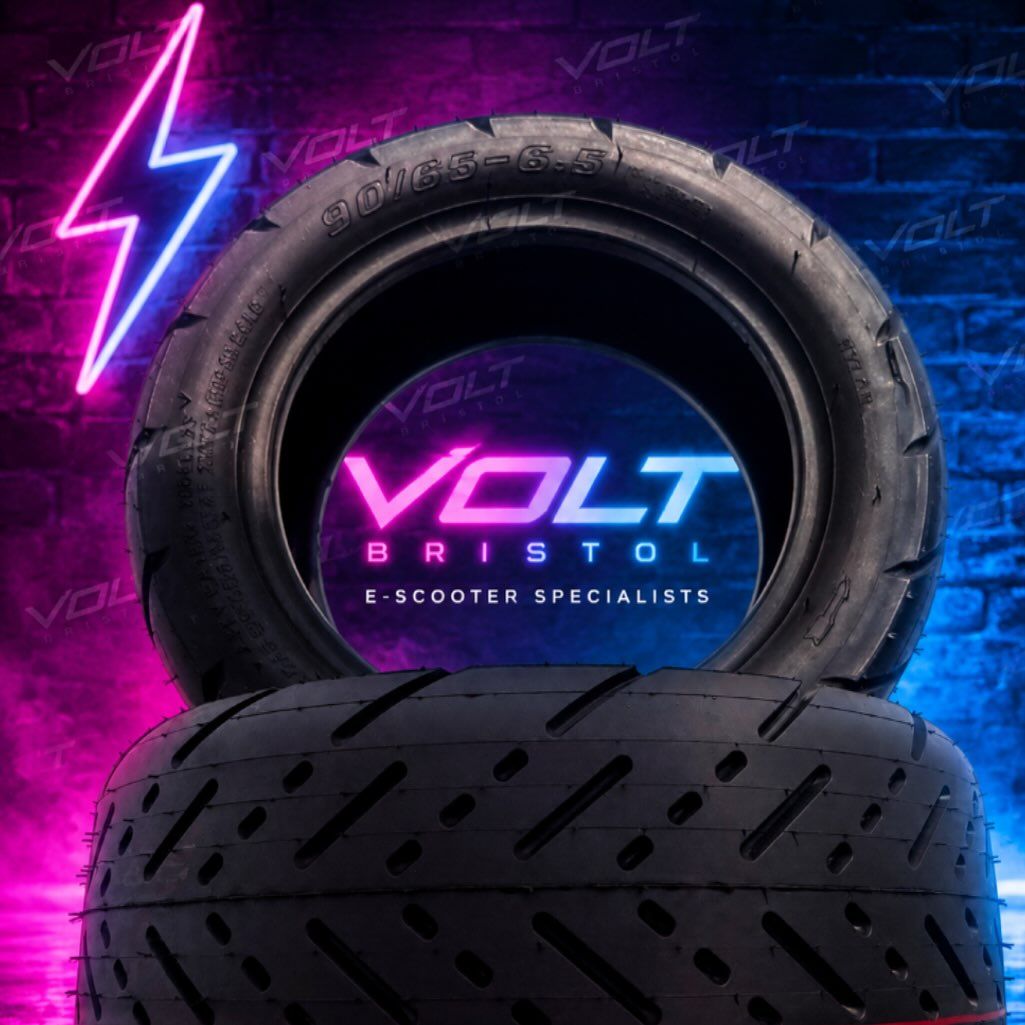 A 90/65-6.5 tubeless tyre lit in neon with the Volt Bristol logo