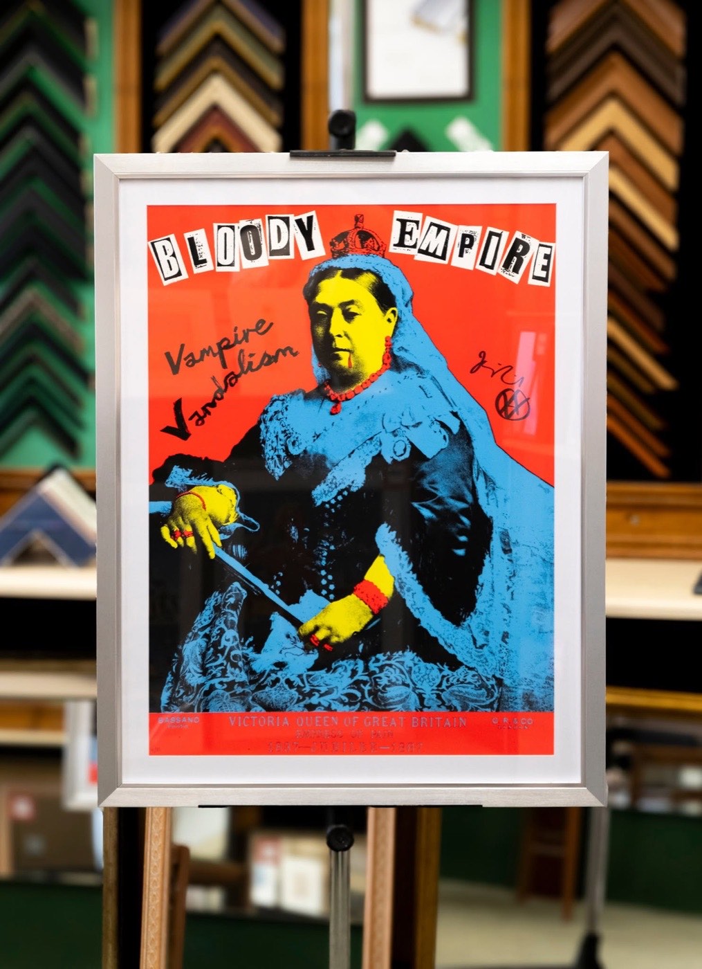 A signed limited edition screen print framed in brushed silver