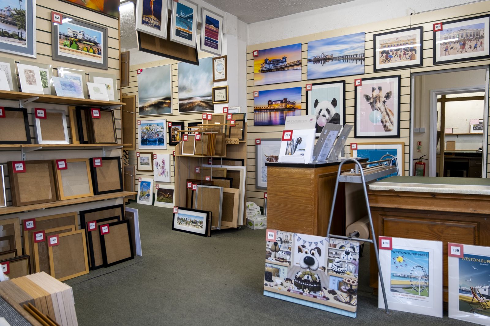 The Weston Super Frames gallery: framed local prints on the walls and ready made frames on the shelves